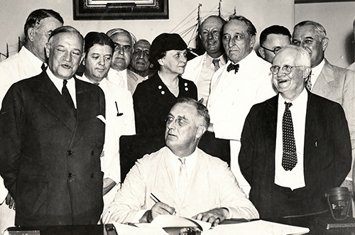 FDR signs the Social Security Act, August 14, 1935